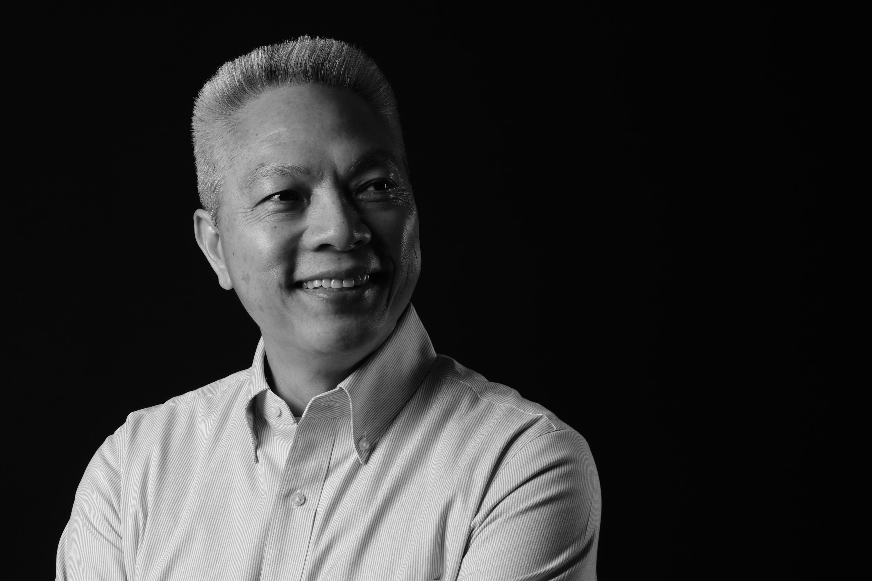 Black-and-white portrait of Jeff Thungc smiling and looking to the side
